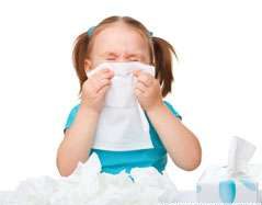 small girld with tissue over her nose as if sneezing or blowing dust or viruses from her nose